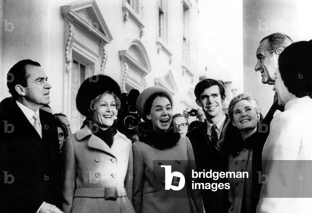 Richard Nixon, Pat Nixon, Julie Eisenhower, David Eisenhower, and Tricia Nixon, are greeted at the White House by President Lyndon Johnson and First Lady Ladybird Johnson, January 20, 1969