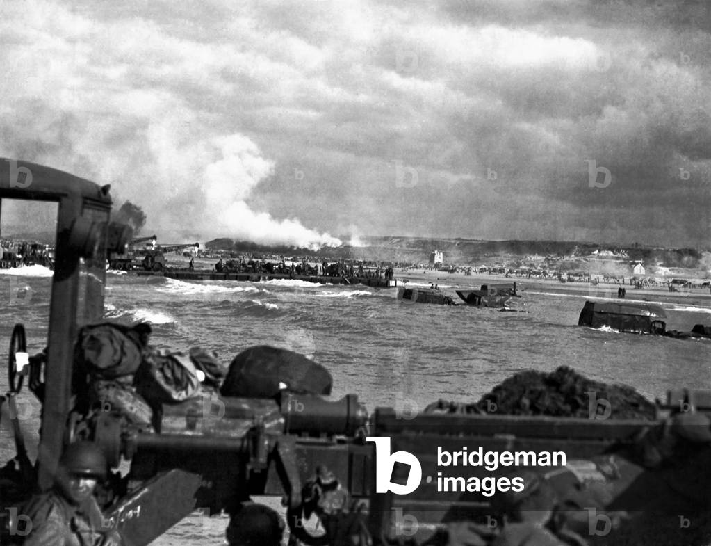 U.S. landing craft approaching Omaha Beach in Normandy beach on Dec. 6, 1944. Soldiers are standing on ships decks, indicating heavy German resistance had ceased. France, World War 2