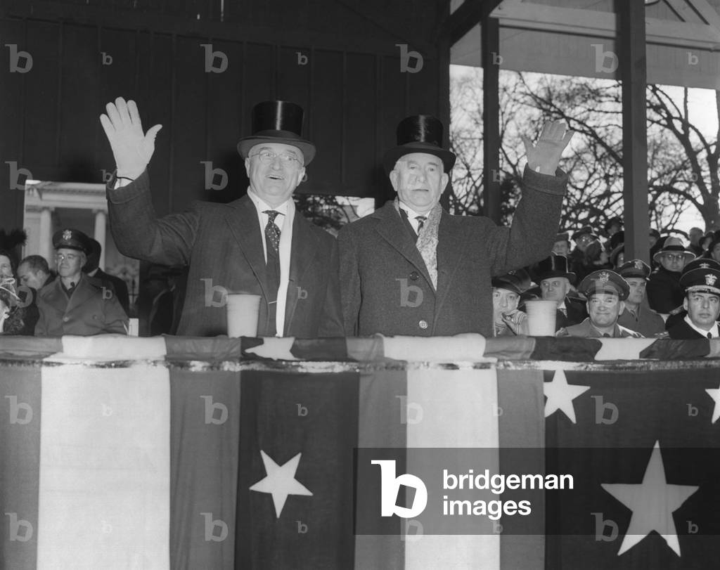 President Harry Truman and VP Alben Barkley wave to cameras during the Inaugural parade. Jan. 20, 1949.