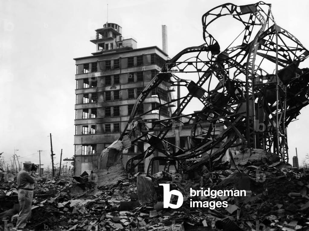 The blasted Chuguko Press building along Hiroshima's main street shortly after the blast. (far left). This building withstood the force of the bomb, but the interior was gutted. ca 1945.