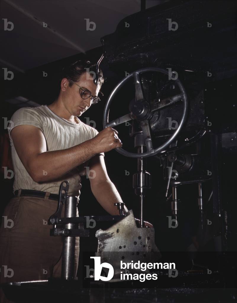 Man operates a drill-press in the North American Aviation's Inglewood, California plant, which built B-25 bombers and Mustang fighters. October 1942,