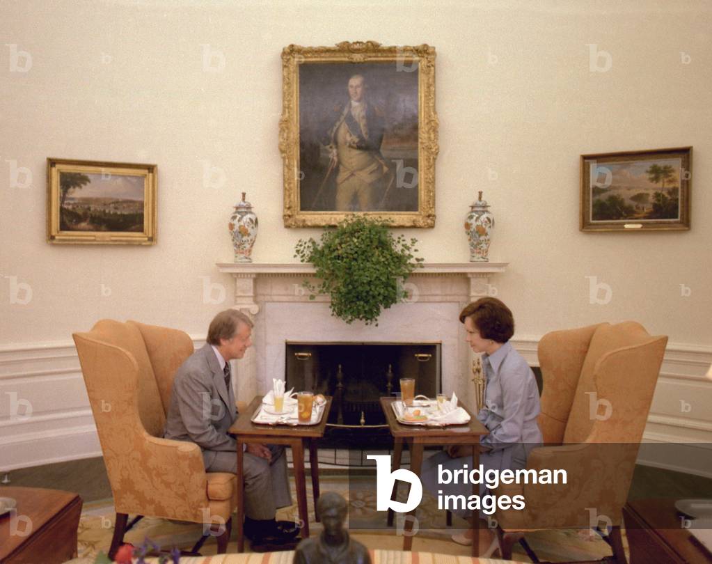 Jimmy Carter and Rosalynn Carter having one of their weekly working lunches in the Oval Office. At this time they discussed issues she advocated and legislative matters of concern to her. c. 1977-1980