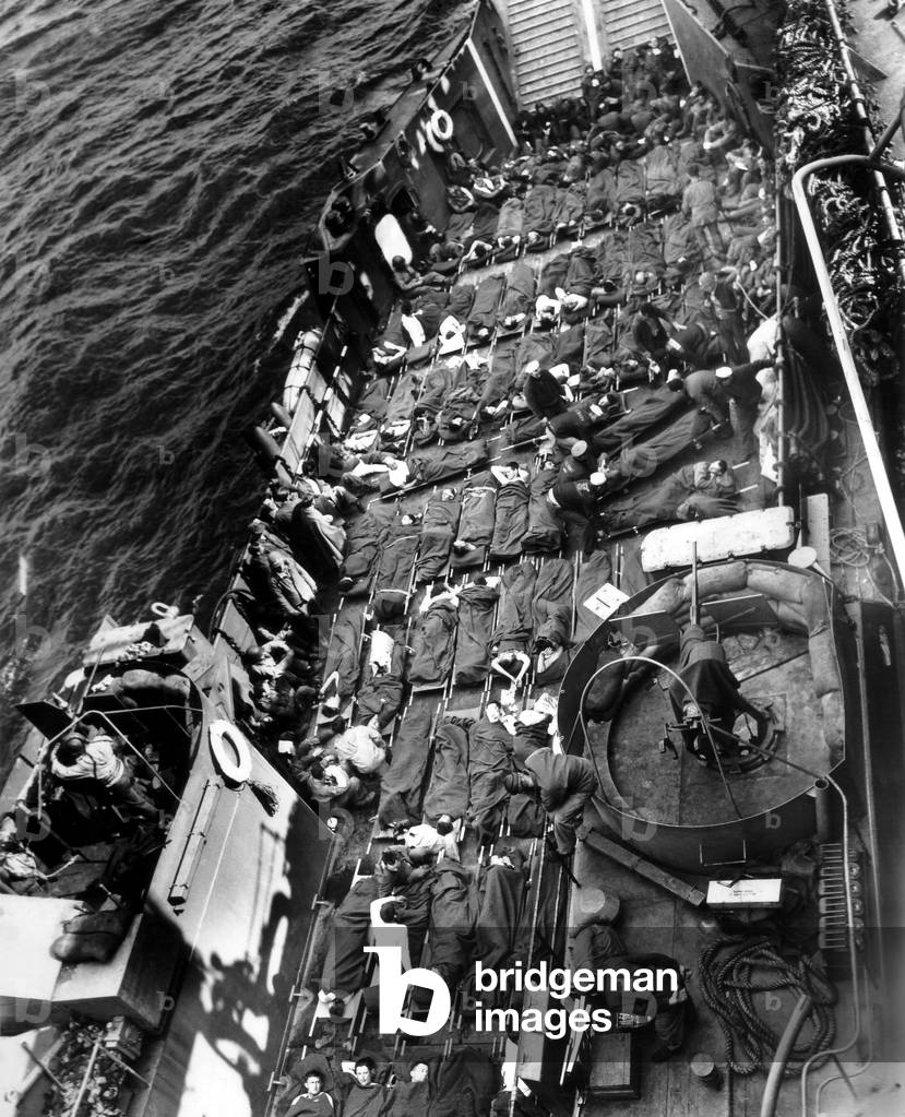 Allied soldiers evacuated from Normandy's beaches on a U.S. landing craft on D-Day. Ships landed tanks and vehicles, and returned to England with their hold filled with wounded. June 6, 1944, World War 2