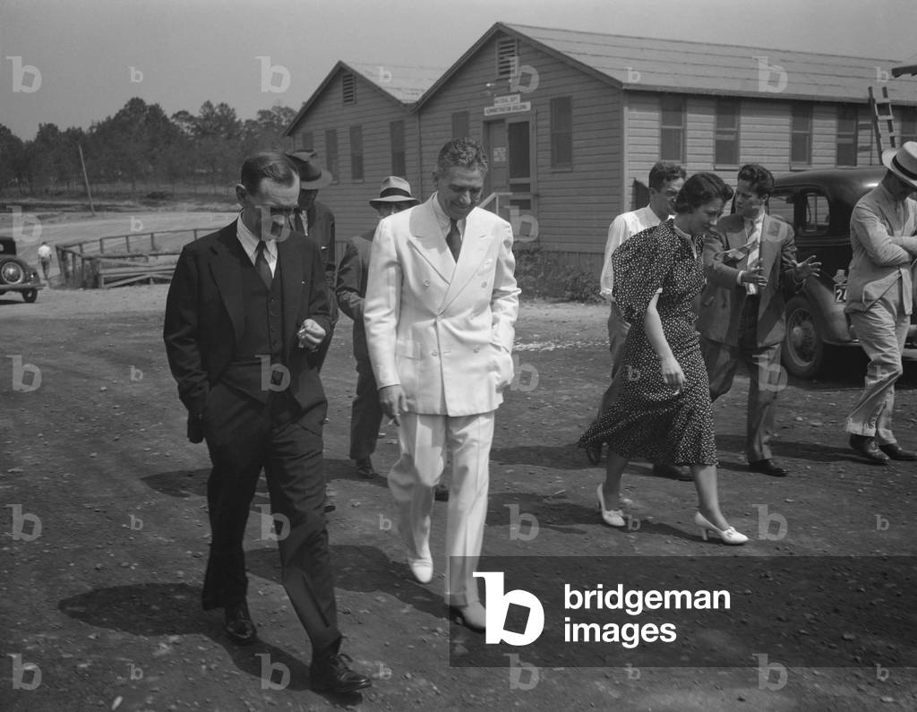 Rex Tugwell and aides visit the Greenbelt planned community in Maryland. July 1936. Greenbelt was designed to provide low-income housing and employment for 885 families
