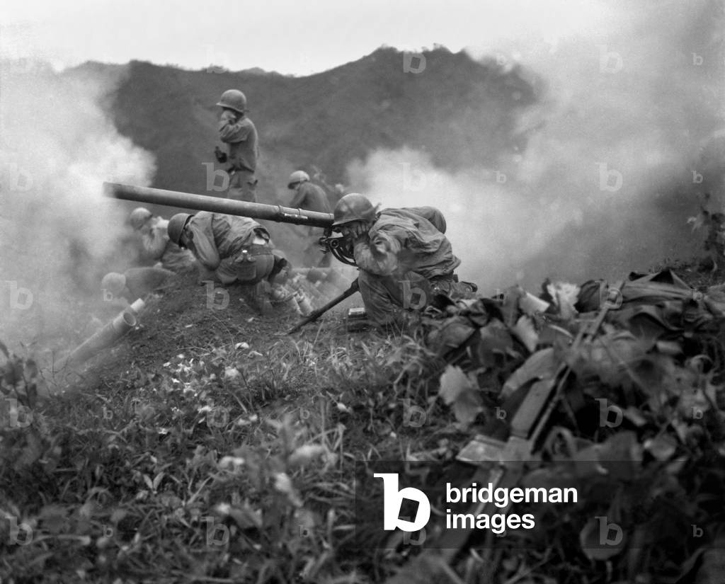 U.S. Army gunner (crouching foreground), fires a 75mm recoilless rifle. They are fighting near Oetlook-tong, Korea, in support of infantry units directly across the valley. June 9, 1951. By the end of June the battle lines near the 38th parallel would change little in the remaining 2 years of the Korean War