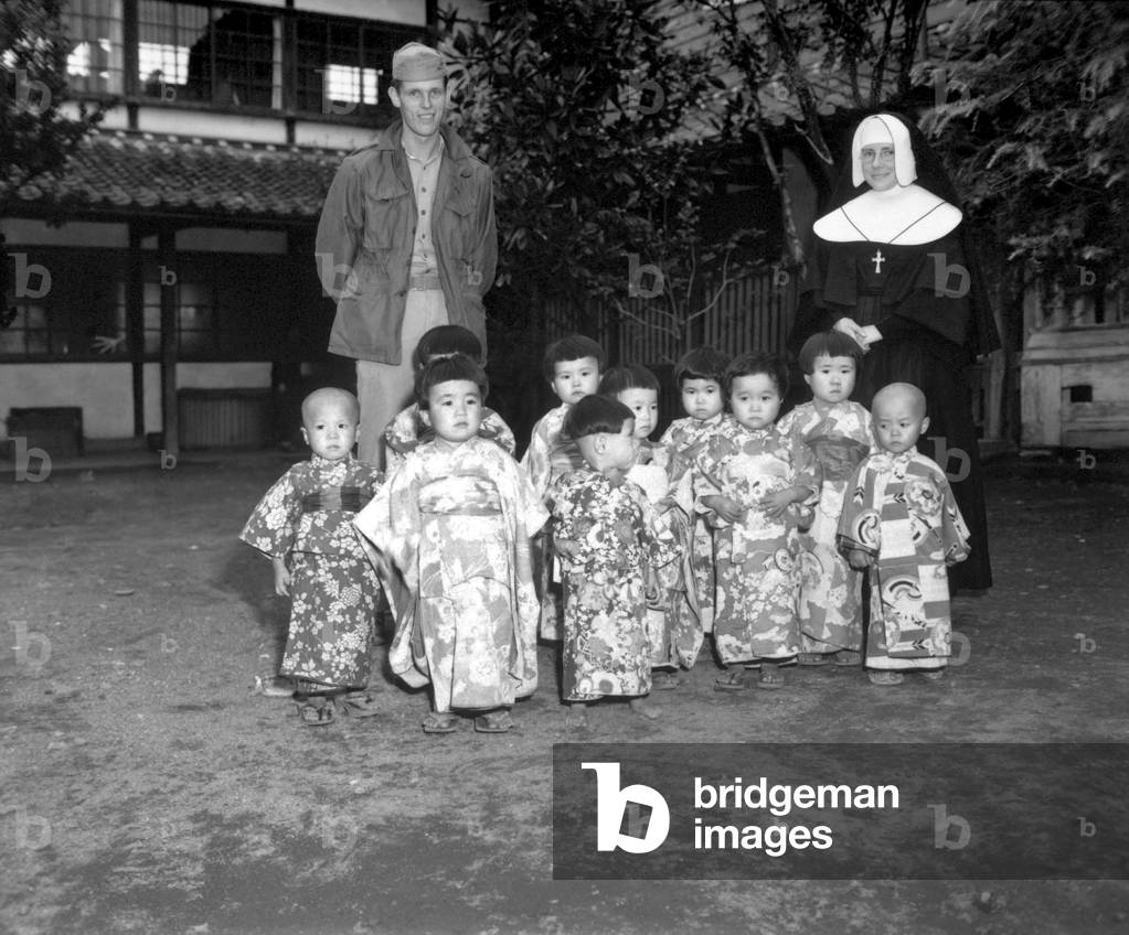 Angel Guardian Home, a Catholic home for orphans, in Kumanoto, Japan. Sister St. Paul had the orphans dress in their finest clothes to have their picture taken by a U.S. Marine Corp photographer. Oct. 25, 1945.