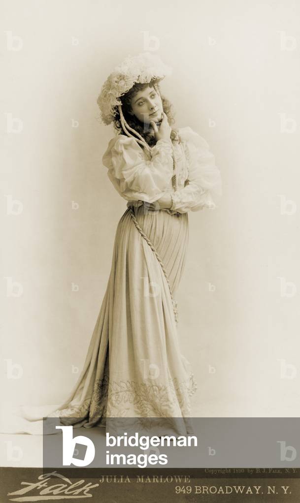 Julia Marlowe (1866-1950), English born American actress, standing, with hand on chin in 1890 portrait by Benjamin Falk