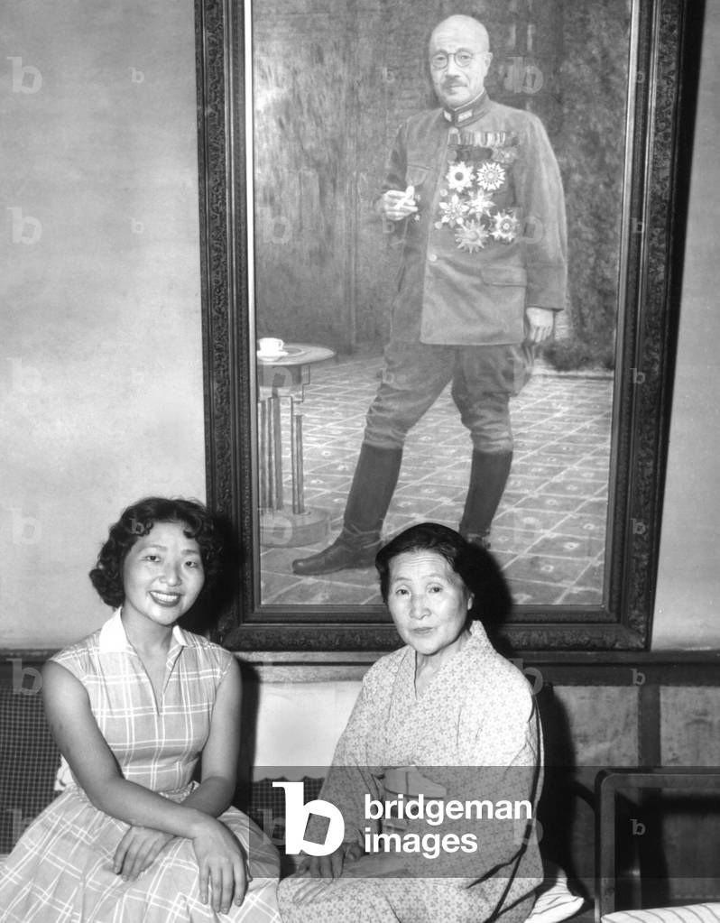 Kimiye Tojo, 26, with her mother, Katseko, before a painting of Japanese Premier Hideki Tojo. Tojo's daughter, Kimiye was offered a scholarship by the Portia Law school in Boston