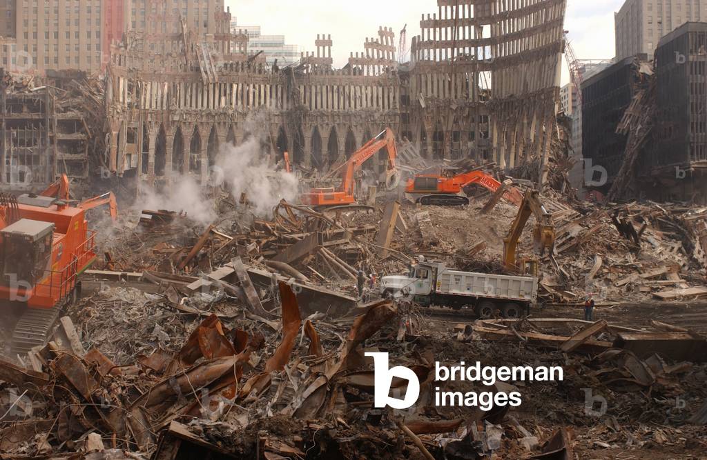 A month after the terrorist attacks heavy equipment continues debris removal at the World Trade Center site. View from the southern edge of Ground Zero. Oct. 13 2001