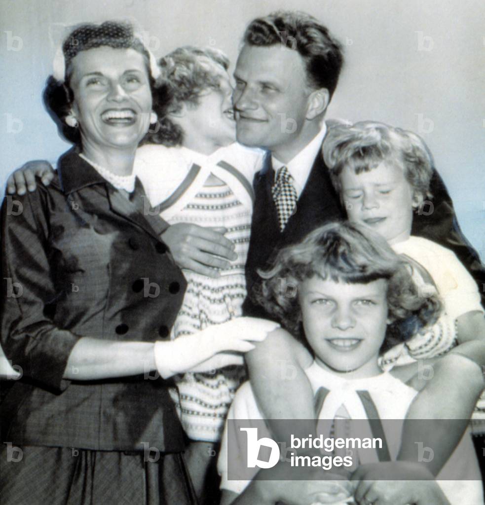 Billy Graham greeted by wife, Ruth & daughters Virginia,8, Anne,6, and Ruth, 3. 7/6/54.