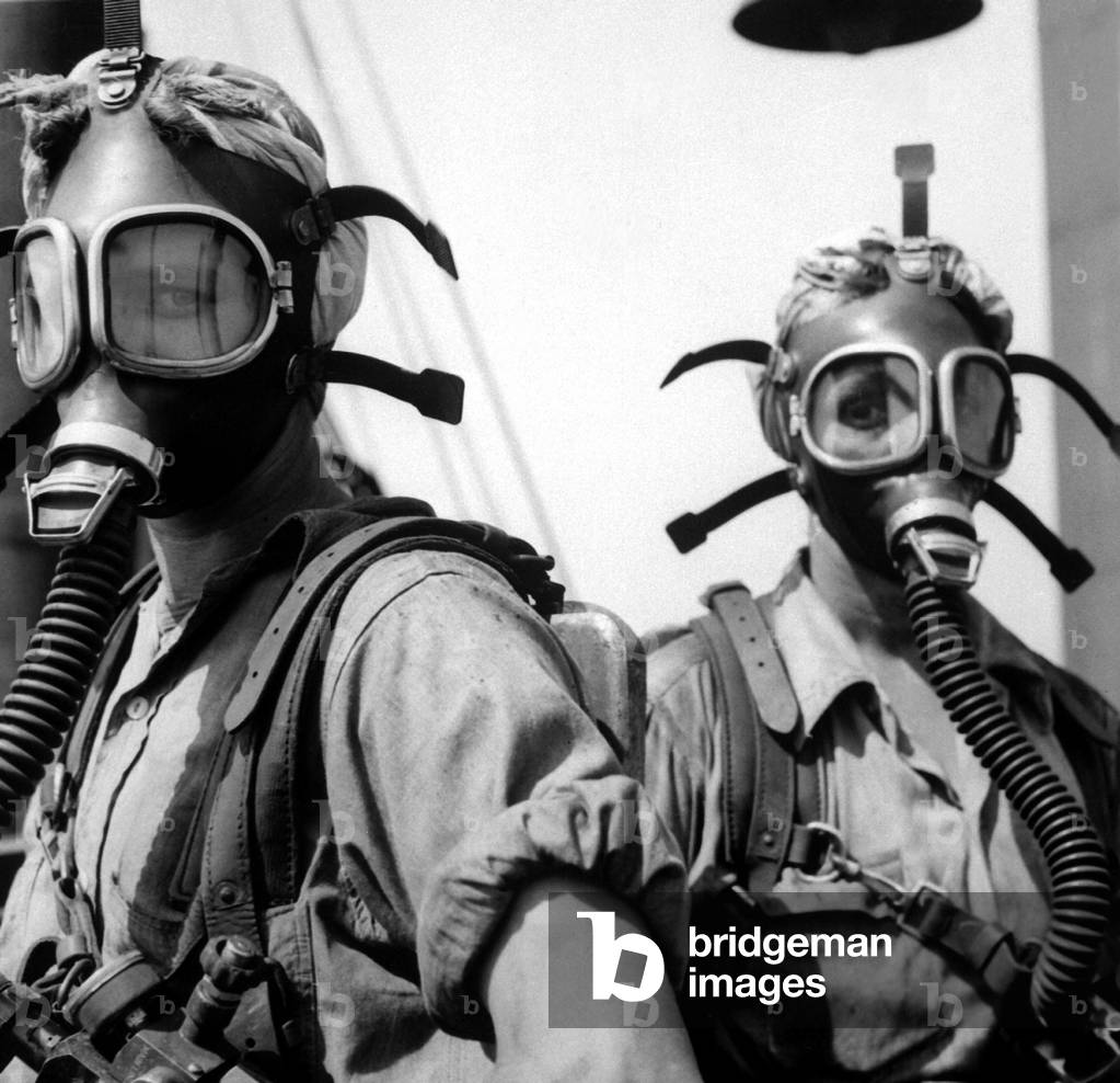 Women war workers wear oxygen masks while cleaning at U.S. Steel Works in Gary, Indiana. c. 1942-45, during World War 2