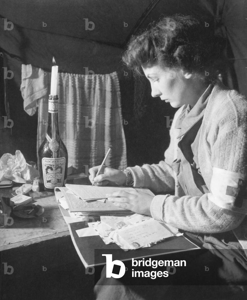 U.S. Army Nurse writes a letter home after 12 hours of work. She is at the 2nd Evacuation Hospital, somewhere in France. July 24, 1944. World War 2