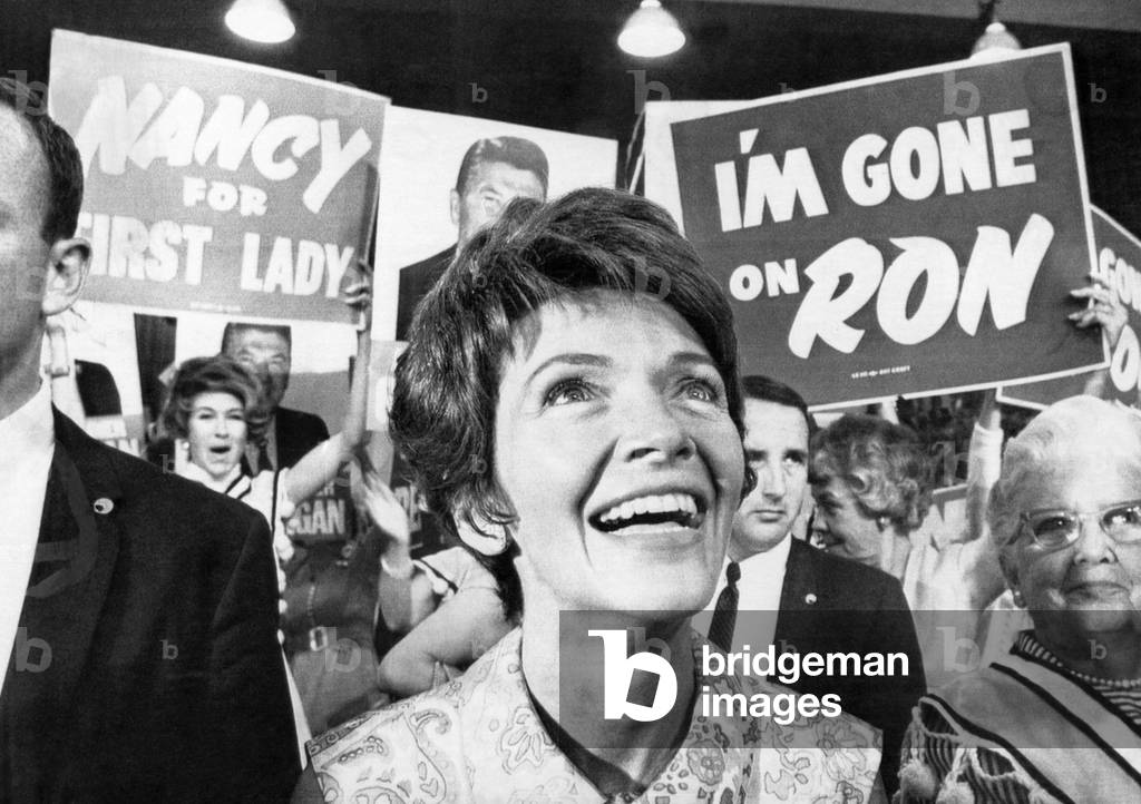 Future First Lady Nancy Reagan at the Republican National Convention, watching the demonstration following Ronald Reagan's nomination as Republican presidential candidate. Signs read 'I'm Gone on Ron' and 'Nancy for First Lady', Miami, Florida, August 7, 1968