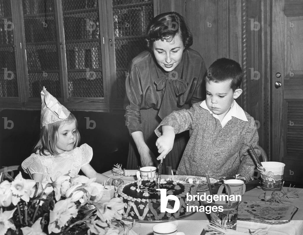David Eisenhower, the President's 5 year old grandson, cutting his birthday cake. March 30, 1953