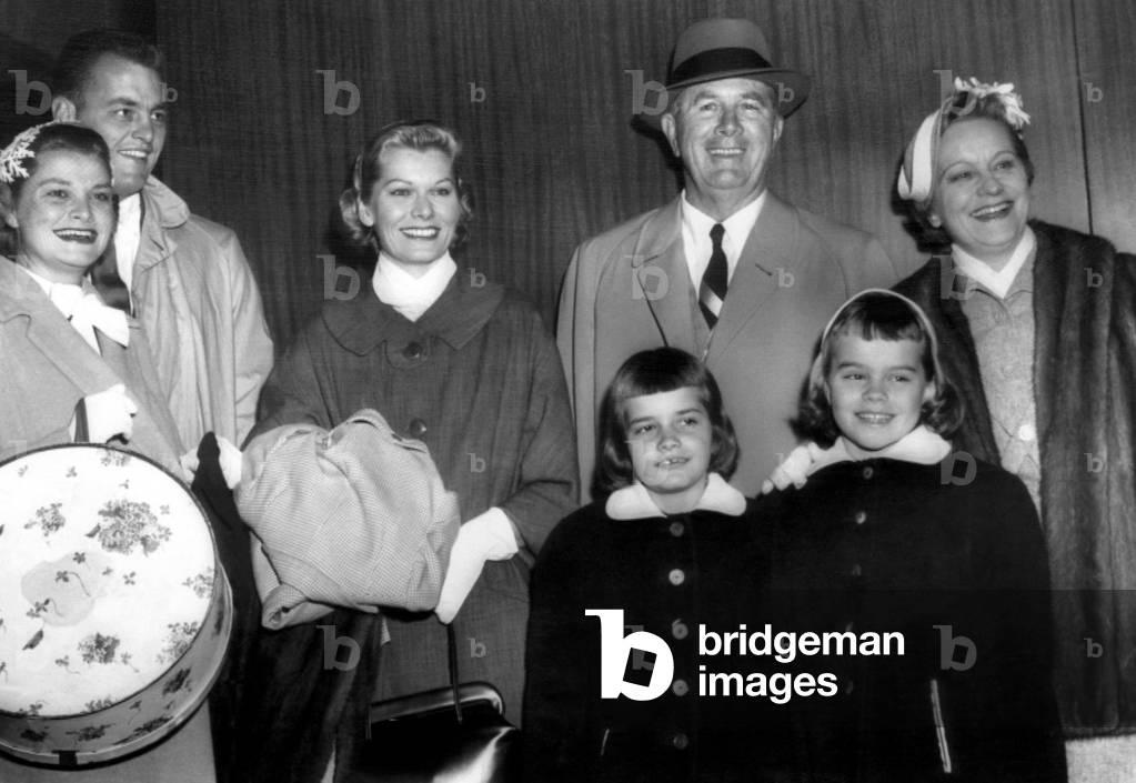 Members of Grace Kelly's family, (l to r: Mr and Mrs Donald Levine, Betty Kelly, Mr and Mrs Jack Kelly and nieces Mary Lee Davis and Meg Davis, on their way to attend her wedding to Price Rainier in Monaco. c. April 1956.