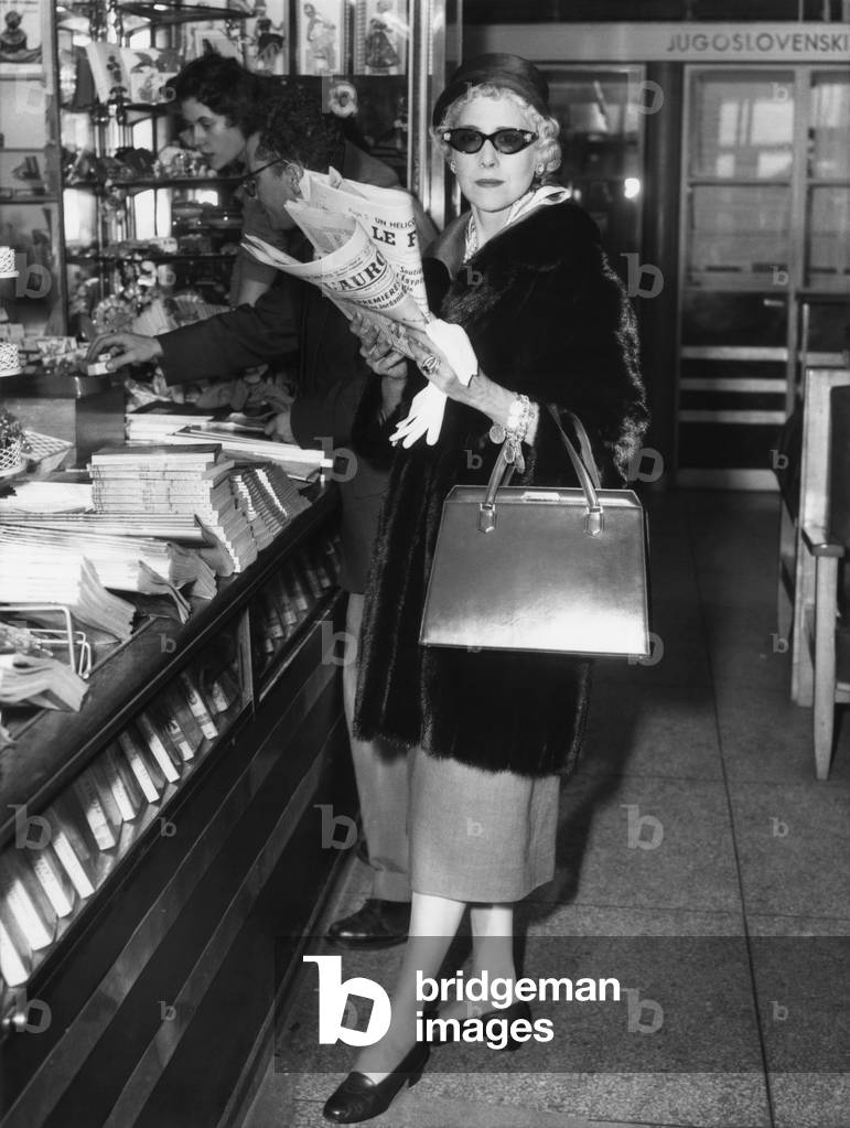 Clare Booth Luce, at a newsstand at Paris' Orly Airport before boarding a plane for Rome. Sept. 12, 1957