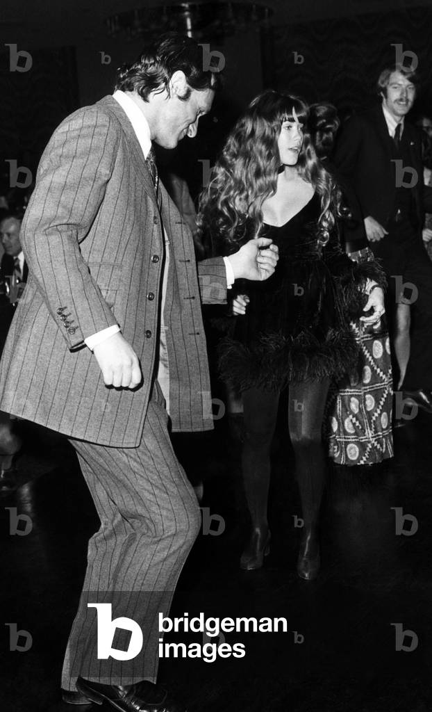 Hugh Hefner and Barbi Benton dance at a party at the Playboy Club-Hotel in McAfee, New Jersey. ca 1972.