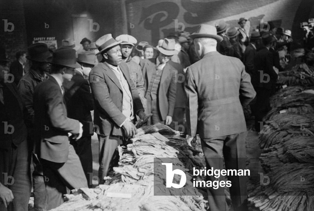 African American farmer negotiating at a tobacco Auction, Durham, North Carolina, Nov. 1939. Photo by Marion Wolcott