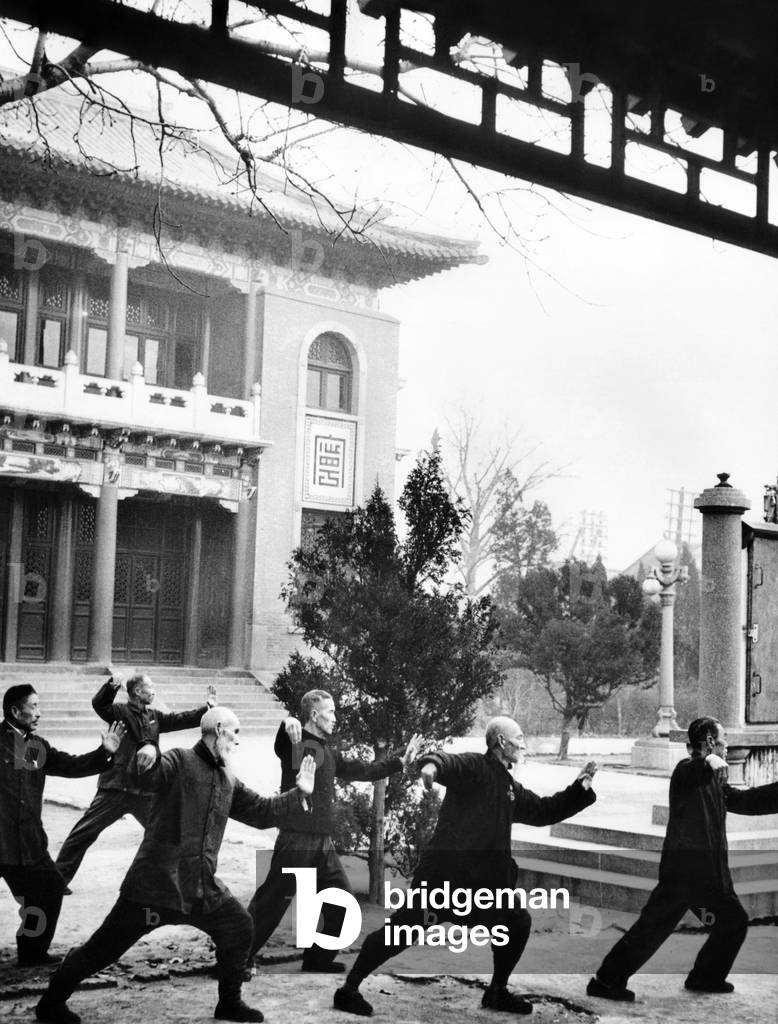 Middle-aged Chinese men practice T'ai chi in Hopei Province, Communist China. Jan. 1962