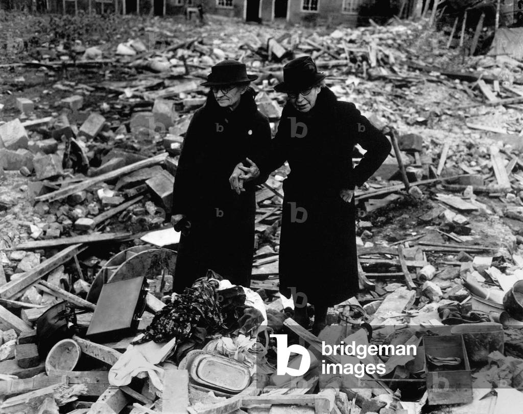 Two elderly women stand amid the ruins of the Almshouse that had been their home. The Germans bomber Newbury, Berkshire, England on Feb. 10, 1943. World War 2