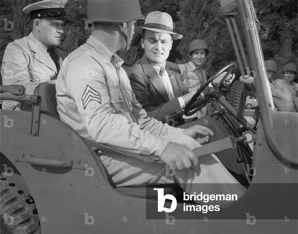 World War II, George Woolslayer (right) examining an army jeep at the post where Sergeant French L. Vineyard (center) is stationed, Aviation-radio Chief John Marshall Evans stands at left, Allegheny-Ludlum Steel, Pittsburgh, Pennsylvania, photograph by Alfred T. Palmer, August, 1942