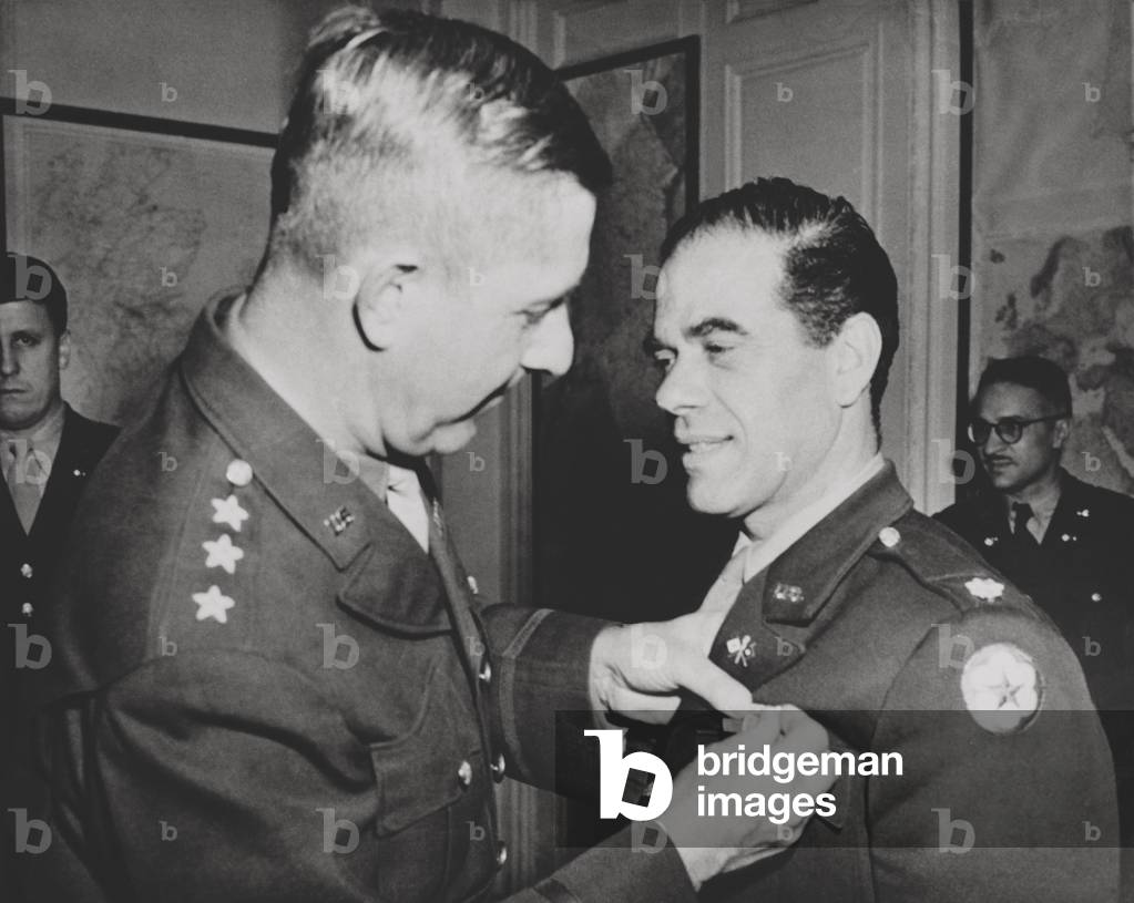 Lt. Col. Frank Capra, receives the Legion of Merit. The Hollywood movie director was chief of the U.S. Army Signal Corps motion picture production unit. He produced, 'Why We Fight', a series of pictures on events leading up to our entry into war, for use in Army orientation courses. Nov. 29, 1943. World War 2