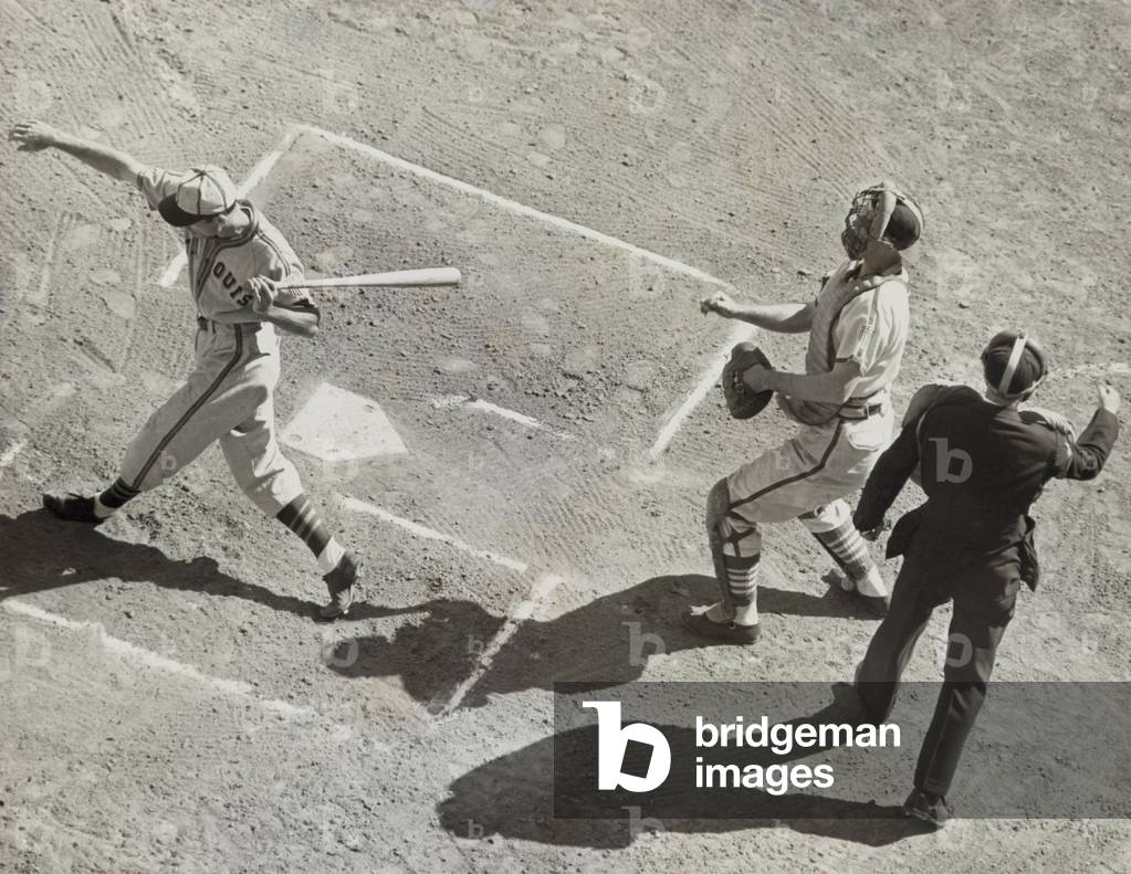 St. Louis Browns' Don Gutteridge striking out in the 2nd game of the 1944 World Series. St. Louis Cardinals catcher Walker Cooper is behind the plate. Oct. 5, 1944.