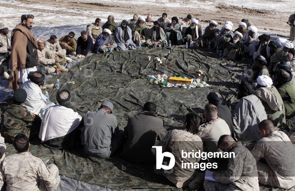 Haji Zahir district governor of Marjeh presided over a shura where he listened to the needs of the Shorshorak village elders and outlined the government's plans for the region. U.S. Marines were in attendance. Jan. 10 2010., Photo by:Everett Collection