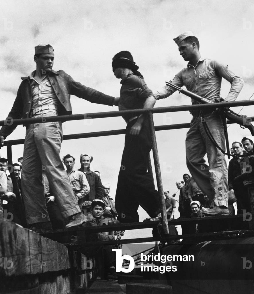 U.S. Marines unloading a Japanese POW from a submarine returned from war patrol. May 1945. World War 2