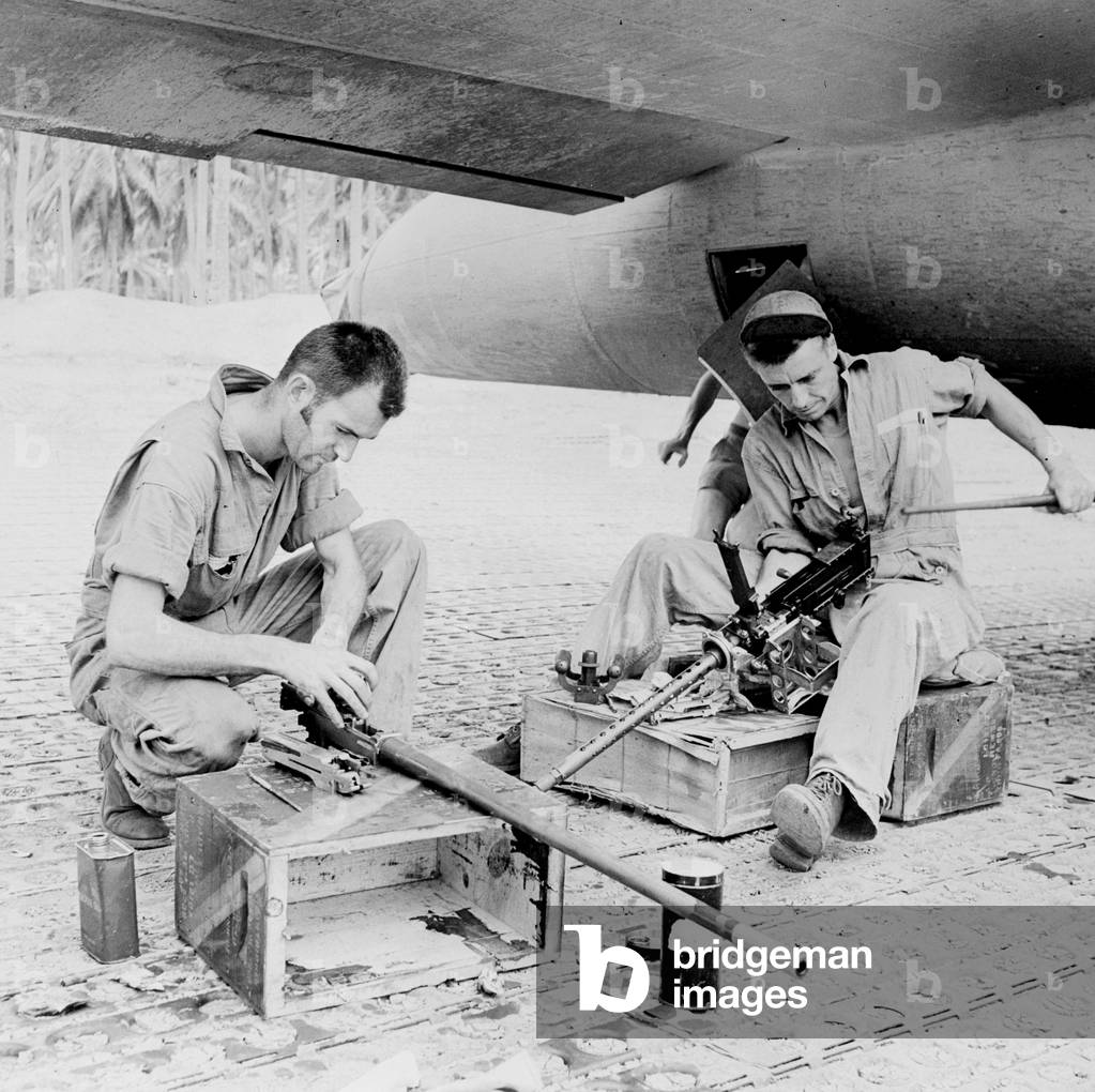 World War II, Sergeant Edward T. Spetch, Sergeant Vernon Nelson, Flying Fortress gunners carefully clean their .50 caliber machine guns at a U.S. Army Air Force airbase in the New Hebrides, c.1942