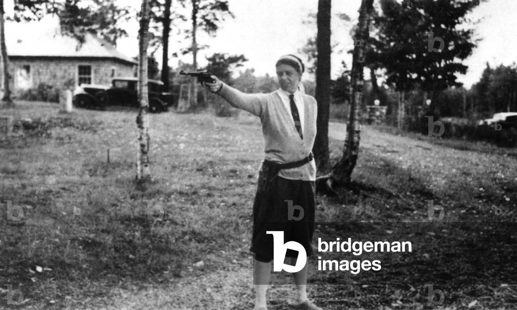 Eleanor Roosevelt at Chazy Lake, New York, firing hand gun. 1934. She was taught to shoot by her former body guard, Earl Miller