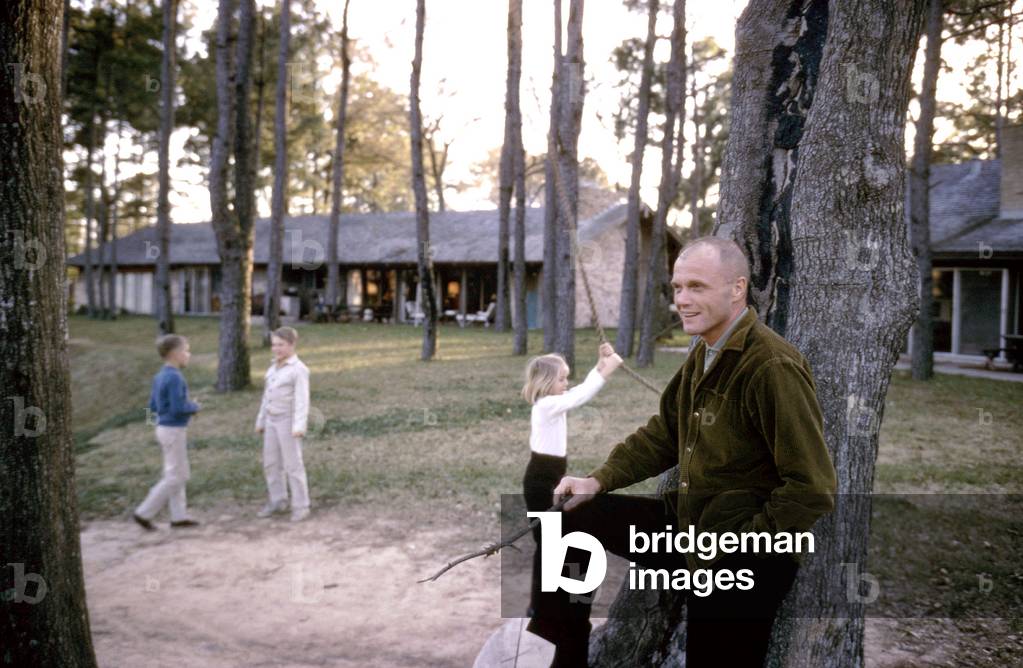 Mercury astronaut John Glenn in front of his house in Ohio with his and astronaut Scott Carpenter's children, 1965