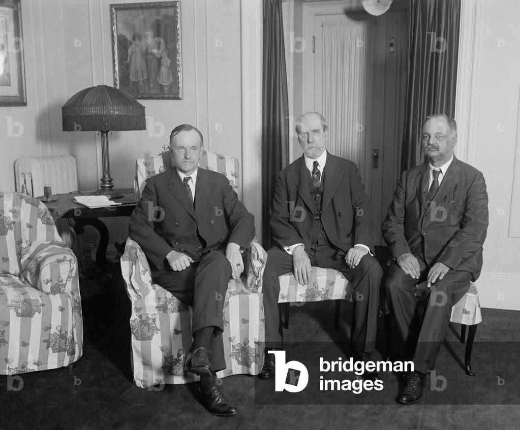 President Calvin Coolidge meeting with Charles Evans Hughes and Charles Curtis, August 3, 1923. Coolidge became President the previous day after Warren Harding died suddenly in San Francisco. Hughes was Secretary of State and Curtis was Senate Minority Whip. They met in the Coolidge family residence at the Willard Hotel, Washington D.C