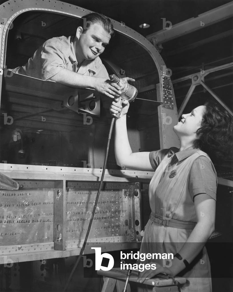 Joe Cobb, former 'fat boy' in the original 'Our Gang' comedies, building B-25 bombers. He worked at the North American Aviation, Inglewood, California, during World War 2. c. 1941-45