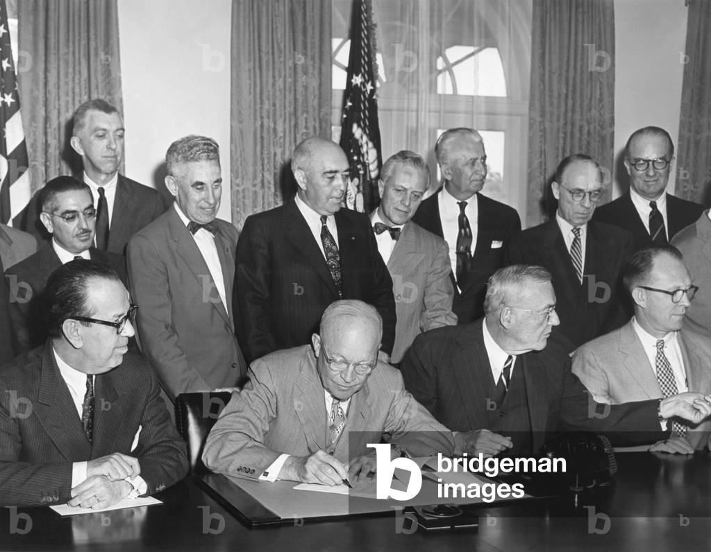 President Eisenhower initialing the first agreement for the Peaceful use of Atomic Energy. May 3, 1955. The international 'Atoms for Peace' program that supplied nuclear equipment to schools, hospitals, and research institutions throughout the world. Nuclear reactors in Iran and Pakistan were built under the program.
