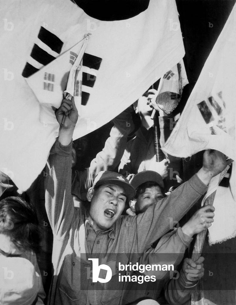 Joyous former POW who refused repatriation to North Korea. He celebrates with fellow ex-prisoners of war. He was released through the U.N. Neutral Nations Repatriation Commission that held 'non-repatriates', for 90 days to consider their choice of nationality. c. Oct.-Dec. 1953. Korean War, 1950-53