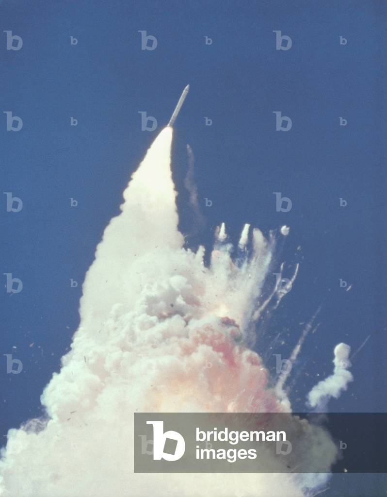 Space shuttle Challenger disaster. 76 seconds into flight, reddish-brown cloud envelops the disintegrating shuttle. Fragments of the shuttle can be seen tumbling against a background of fire. Jan. 28, 1986