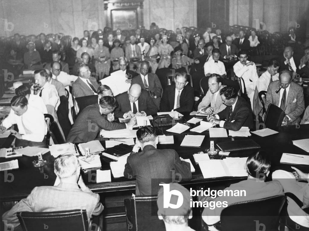 Senate munitions Investigating Committee, Sept. 12, 1934. General view as the DuPonts begin their testimony. L-R at table: Stephen Rauschenbach, Chief investigator for the Senate Munitions Committee; Pierre DuPont, Lammont DuPont, and Felix DuPont. -