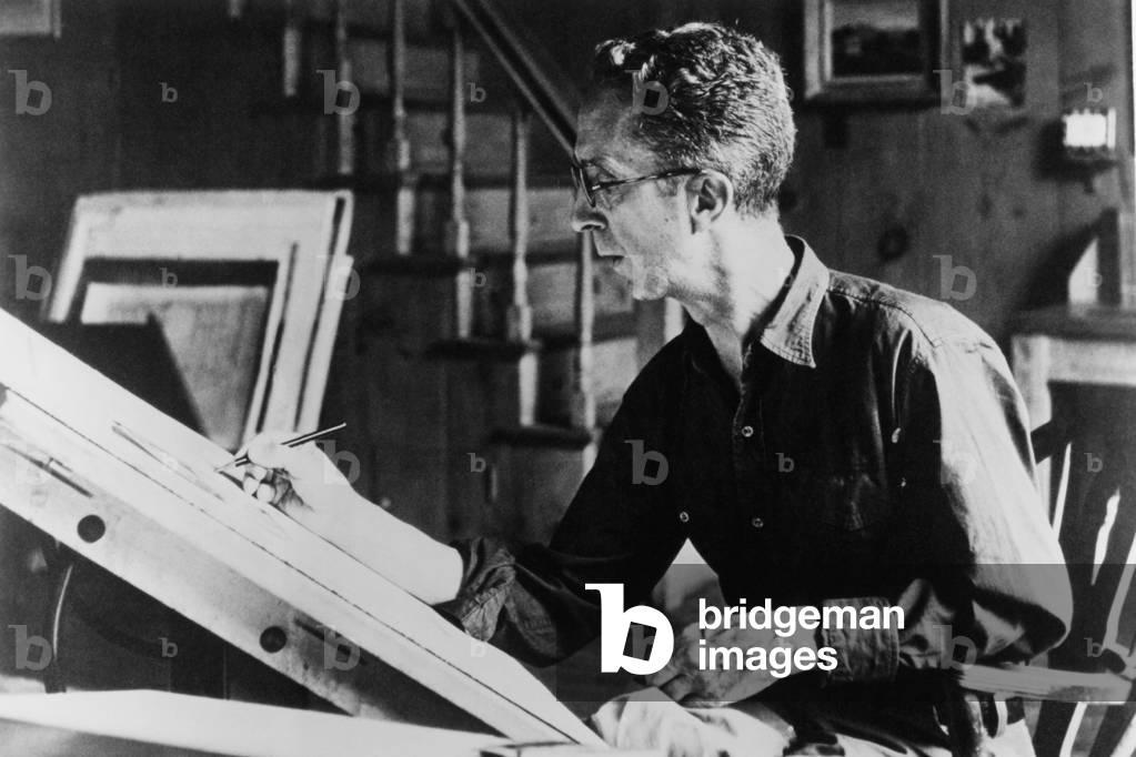 Norman Rockwell (1894-1978), American painter, at his drawing board, c.1940s