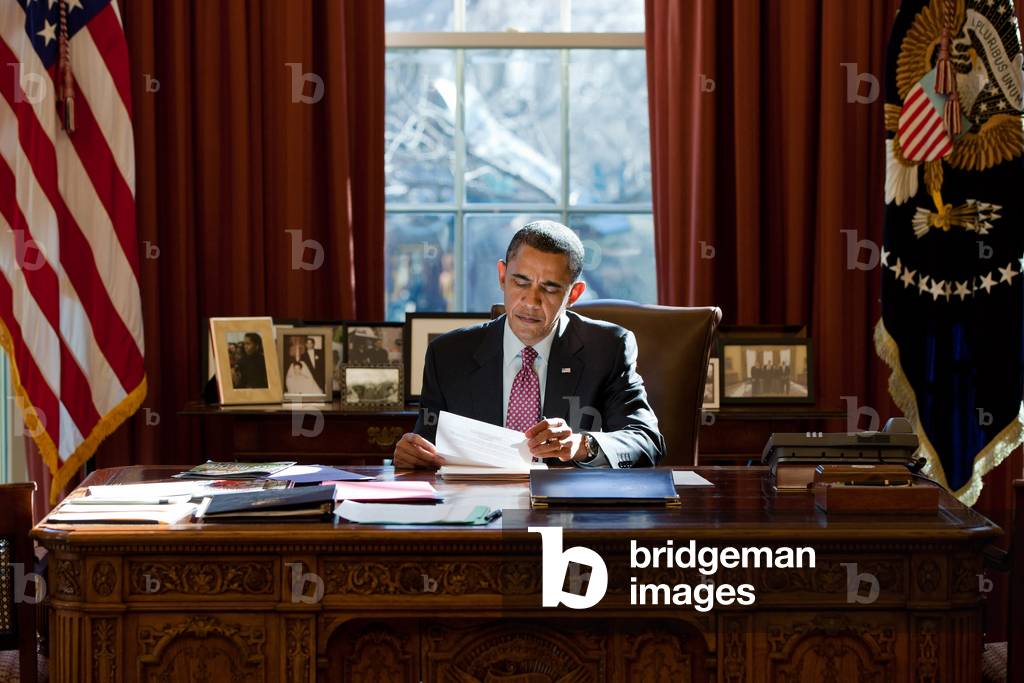 President Barack Obama reviews his prepared remarks on the political crisis in Egypt at the Resolute Desk in the Oval Office Feb. 11 2011.,