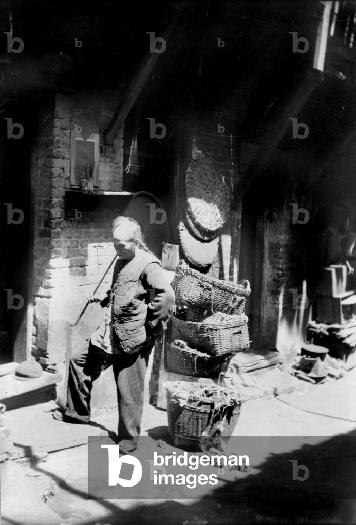 Chinese man smoking long pipe, rag pickers alley, San Francisco, California, photograph, 1921