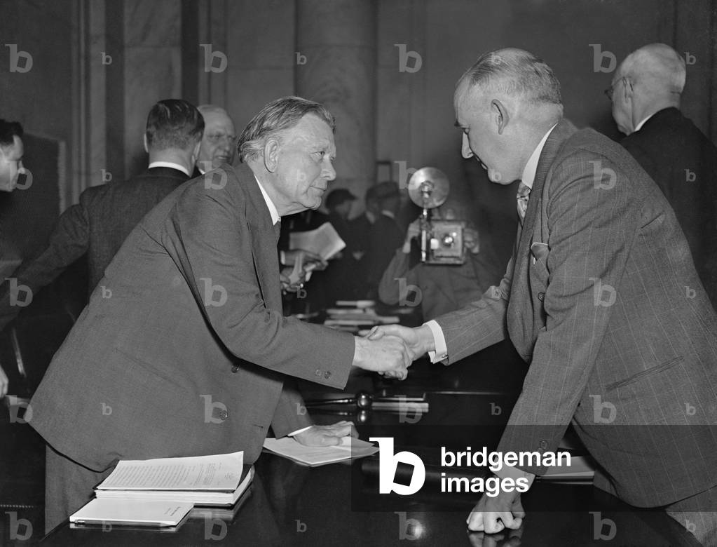 William Borah greets former 'Brain Truster' Raymond Moley. Mar. 23, 1937. Moley joined Borah and the Republicans in opposition to FDR's court packing scheme. Moley was an early FDR ally but drifted away and eventually became a conservative Republican
