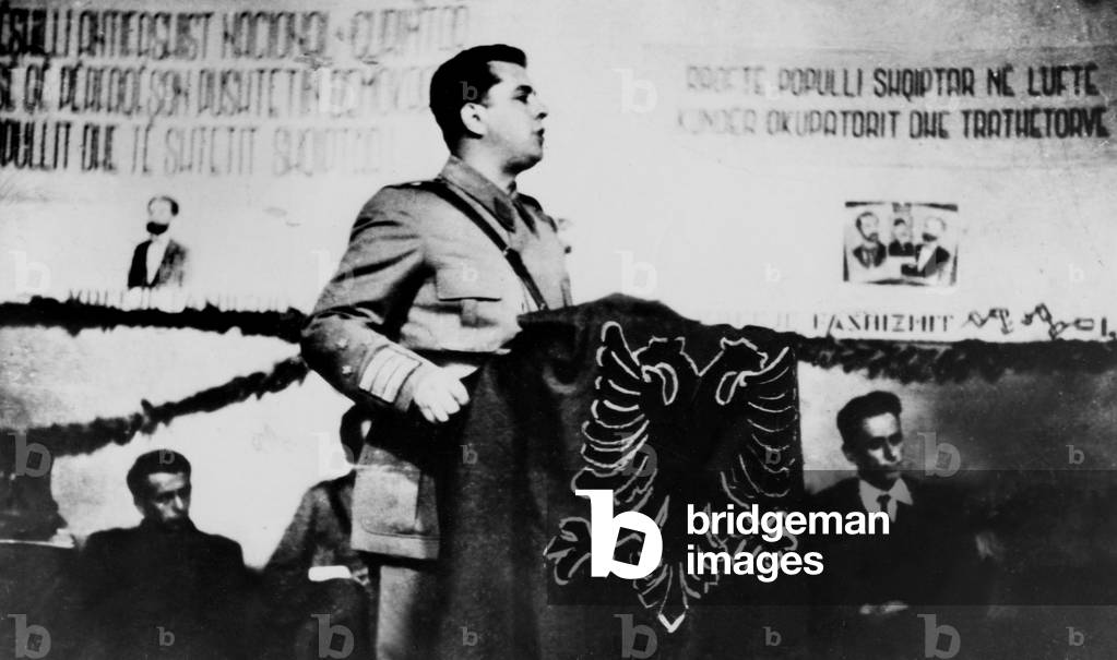 COL. GENERAL ENVER HOXMA, 36-yr.old commander of the Albanian armi and Prime Minister addresses a eople's congress inside a liberated Albania. 3-12-46