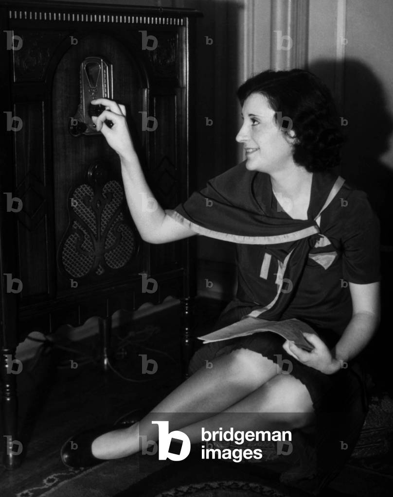 woman listening to the radio, c.1930s (b/w photo)