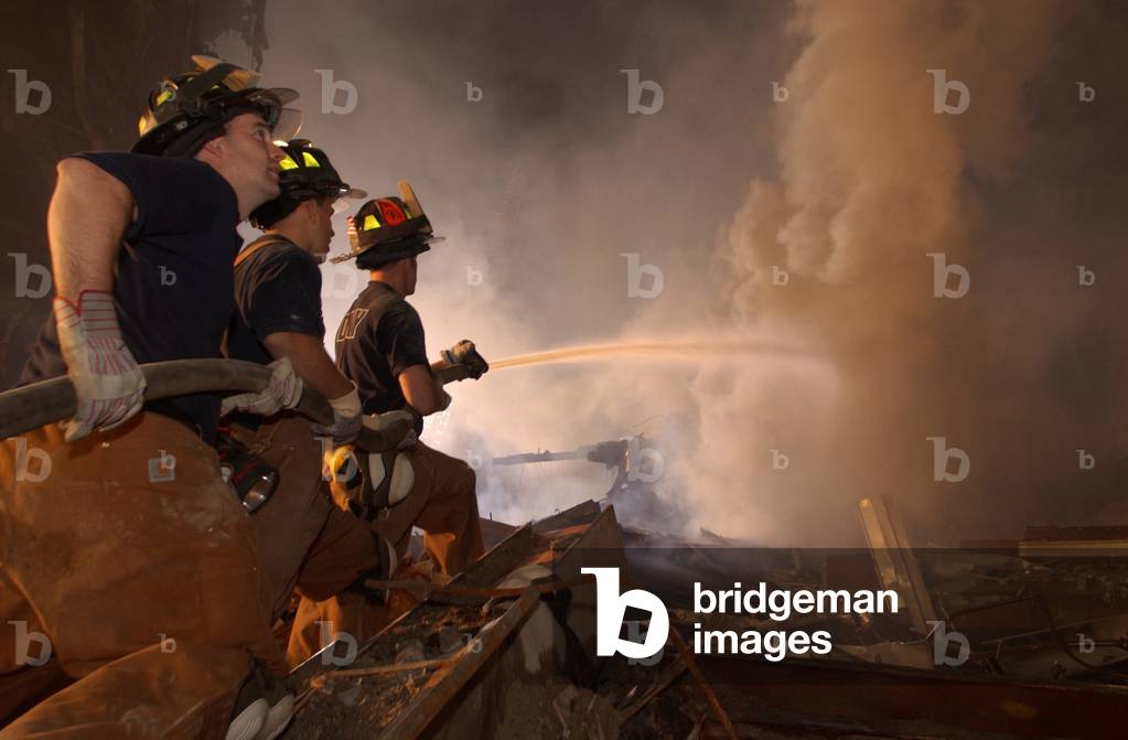 New York firefighters continue to battle blazes at Ground Zero eight days after the 9-11 terrorist attacks. Sept. 19 2001