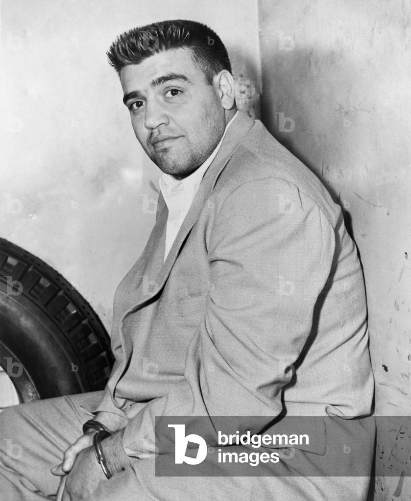 Vincent Gigante (1928-2002), future boss of the Genovese crime family, in police custody for a 1957 shooting. In the 1990s he feigned dementia by roaming his Greenwich Village neighborhood in slippers and a bathrobe and successfully avoiding prosecution until 1997