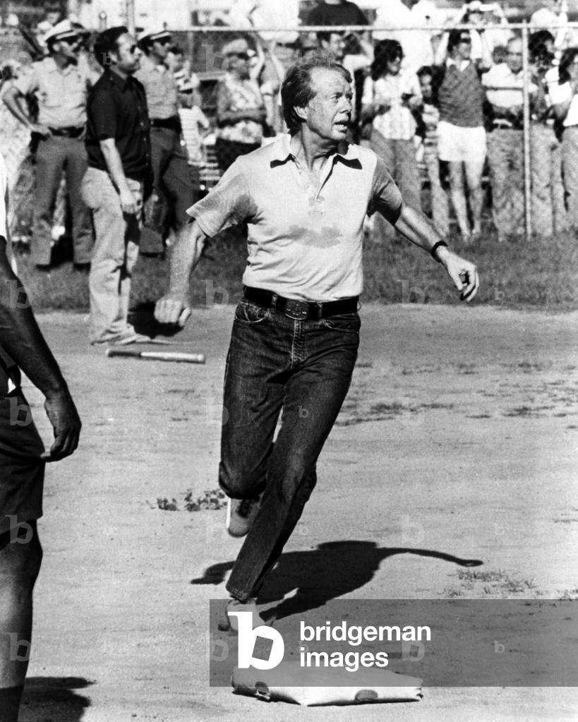 President Jimmy Carter reaches home base in a softball game during a vacation, 1977