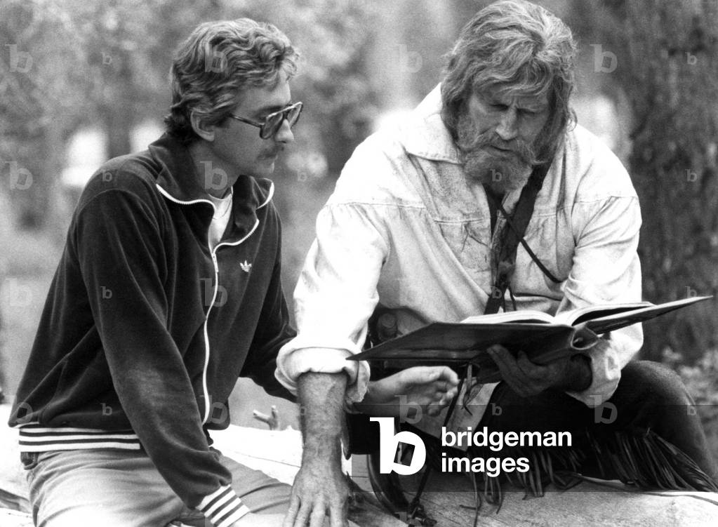 Writer-director FRASER HESTON goes over script with father CHARLTON HESTON during THE MOUNTAIN MEN, 1980