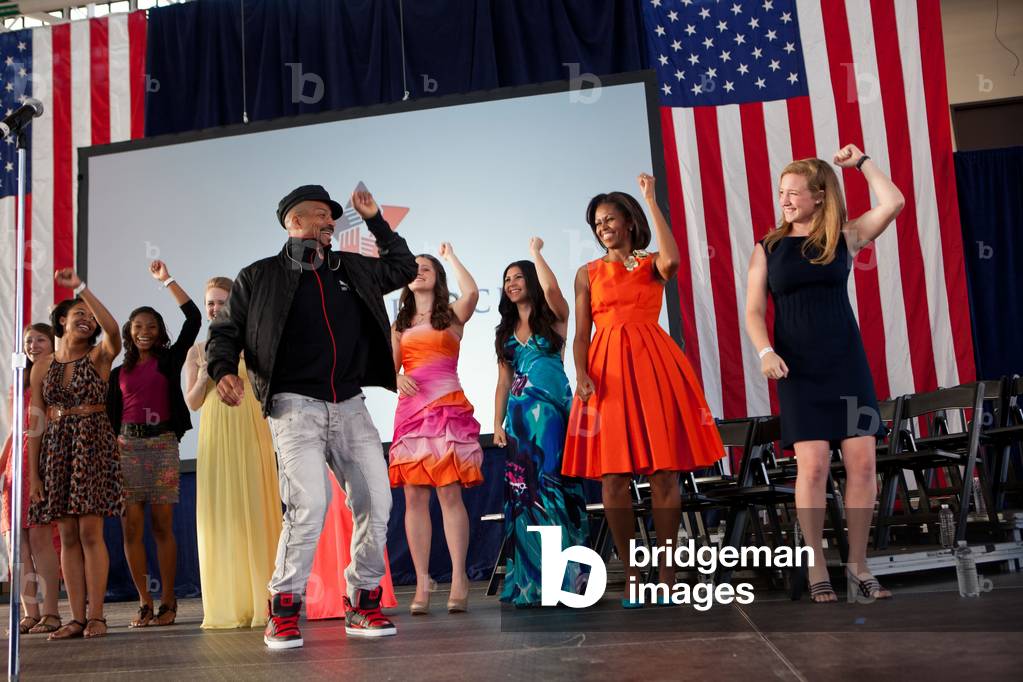 Choreographer Rosero McCoy leads a dance event at Jacksonville Naval Air Station. First Lady Michelle Obama and teen participants are at an event of 'Joining Forces,' a support group for service members, veterans, and their families. April 12, 2012 (photo)