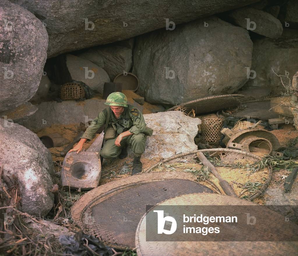 Vietnam War. US Army infantryman, searches a destroyed Viet Cong supply cave in the An Lao Valley during Operation Pershing. July 7, 1967